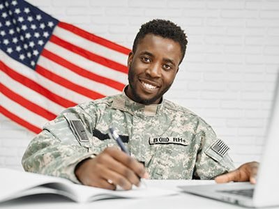 Happy soldier writing documents