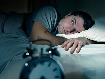 Man suffering with insomnia and sleep disorder