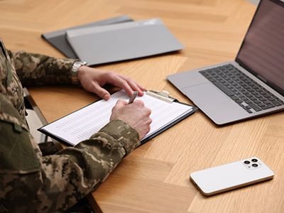 Soldier working at wooden table